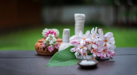 Thai Spa treatment and Spa herbal compressing ball with candle on wooden background. Healthy Concept