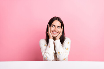 Photo of cheerful dreamy lady wear white cardigan arms cheeks looking empty space isolated pink color background