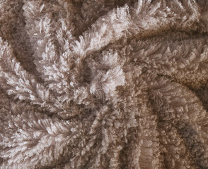 Fluffy fur fabric macro texture for background. Fuzzy fabric for winter day. Beige fur, winter fabric textile. Soft furry  fabric background. Super soft, vela, plush. Fluffy effect. Earth tone surface