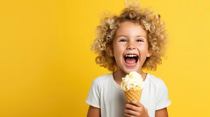 Poster Cheerful happy child girl hold sweet ice cream in hands, eat ice-cream on flat yellow background with copy space.  © IndigoElf
