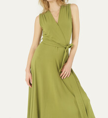 
Serie of studio photos of young female model in green viscose wrap dress. 