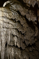 The cave is karst, amazing view of stalactites and stalagnites illuminated by bright light, a beautiful natural attraction in a tourist place.