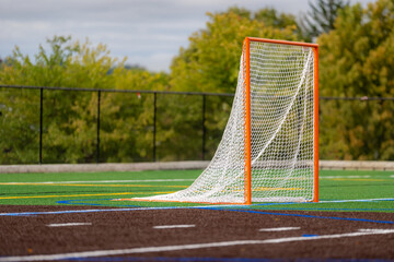Photo of a lacrosse goal on a empty green synthetic turf field.	 - obrazy, fototapety, plakaty