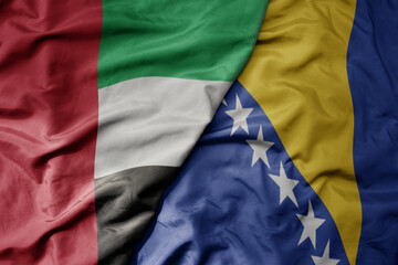 big waving realistic national colorful flag of united arab emirates and national flag of bosnia and...