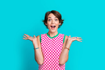 Photo of lovely optimistic girl wear plaid stylish clothes celebrating victory unbelievable offer isolated on cyan color background