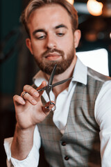 Handsome barber is in the salon