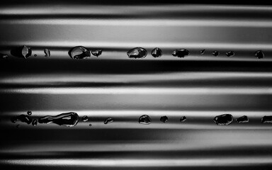 Pattern of Raindrops on Corrugated Roofing in Black and White
