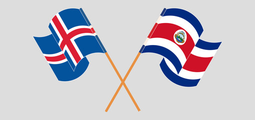 Crossed and waving flags of Iceland and Costa Rica