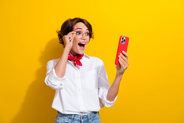 Photo of young girl wear white shirt red kerchief neck touch eyeglasses shocked tweet crazy elon musk isolated on yellow color background - obrazy, fototapety, plakaty