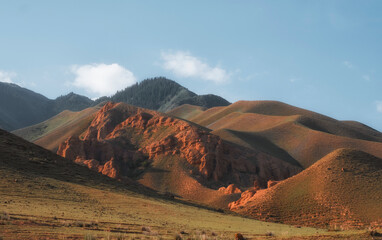 Tract Zhaman uy in mountains of Kazakhstan on platey Assy. Fantastic clay remains of red color in summer