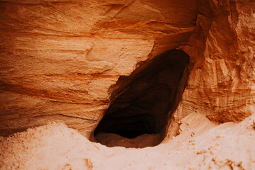In the photo, a sandy canyon forms a small cave, suggesting exploration of uncharted terrain...
