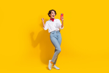 Fototapeta na wymiar Photo of cheerful crazy girl wear trendy clothes speaking with friends social media telegram whatsup isolated on yellow color background