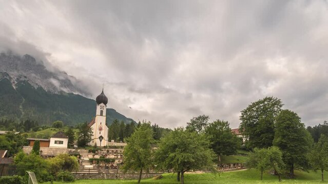 Alps mountain range time lapse and Zugspitze Peak top of Germany, Grainau Village Garmisch Partenkirchen timelapse 4K