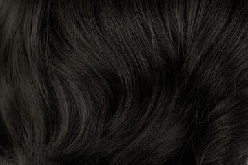Close-up view of natural shiny dark hair, bunch of black brunette curls background - obrazy, fototapety, plakaty