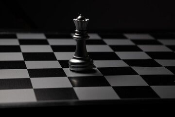 Silver Queen Chess Placed on a chess board in a dark room. For creating business-related content 