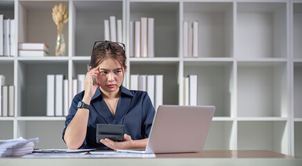 Fototapeta premium The accountant is stressed while calculating the mismatched taxes and finances.