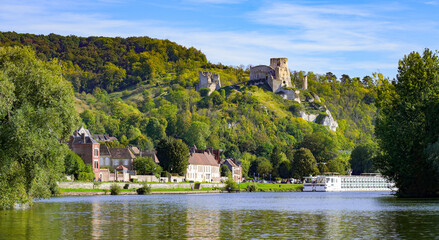 Fototapeta na wymiar View of the River Seine in the Norman town of Les Andelys, overlooked by the ruins of Château Gaillard, a medieval castle built by the King of England Richard the Lionheart in Normandy, France