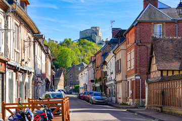 Timbered houses in the Norman town of Les Andelys, overlooked by the ruins of Château Gaillard, a medieval castle built by the King of England Richard the Lionheart in Normandy, France - obrazy, fototapety, plakaty
