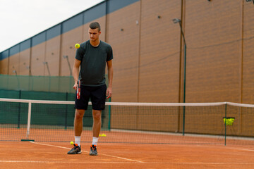 Fototapeta premium young tennis player coach hitting the ball with a racket on the tennis court preparing for the competition sports lifestyle