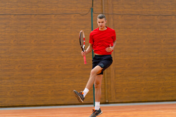 portrait of a young professional tennis player rejoices at the victory at the tournament competition on the open court winner sport game