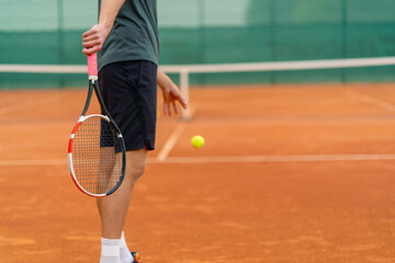 young professional player coach on outdoor tennis court practices strokes with racket and tennis ball
