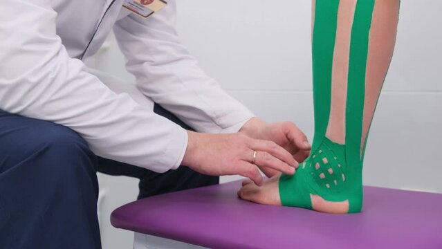 The doctor examines the patient's diseased ankle joint for fractures. The concept of ankle disease, sprains. Taping.