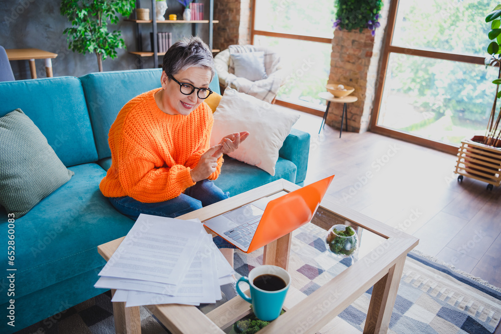 Wall mural photo of smiling charming mature lady dressed orange sweater online video conference modern gadget i