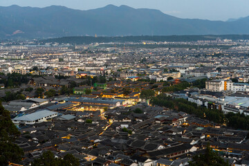 Lijiang Old Town bird eye view with local historical architectures roof building in twilight time