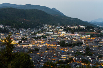 Lijiang Old Town bird eye view with local historical architectures roof building in twilight time