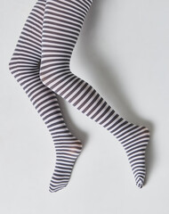 tights in black and white stripes on the legs girls isolated 