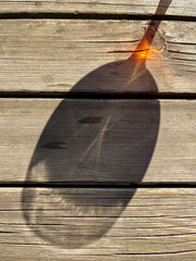 View of a glass shadow on a wood background