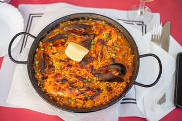 juicy paella with seafood king prawn muscles and fish on a hot pan