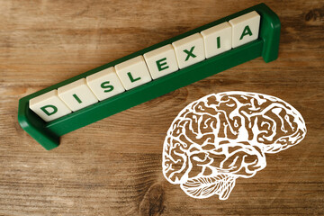 human brain, alphabet blocks, DYSLEXIA word on wooden background, learning disability, dyslexia...