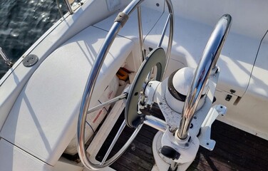 Binnacle on yacht with wheel and controls for steering boat on course