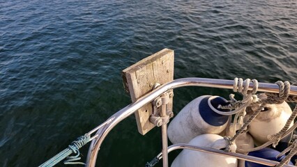 Outboard bracket on rail of sailing yacht