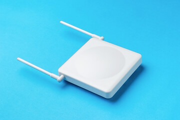 A router for distributing wifi signal with antennas spread out on a blue background.
