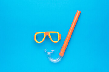 A set of snorkel and mask for scuba diving on a blue background. An accessory for scuba diving.