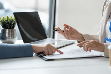 Businesswoman, office worker working using laptop and mobile phone in real estate accounting analysis reporting, discussing agreement contract documents financial and tax system concepts.