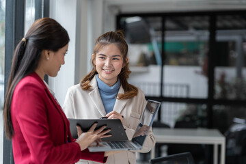 Manager or supervisor with two asian businesswoman having a discussion communication Negotiate project documents Analyze the marketing plan. business investment in finance, tax, office interior