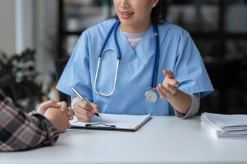 Asian female doctor using a stethoscope to examine a patient, ask for information, give advice, comfort, plan a course of treatment and preventive care. concept of health check