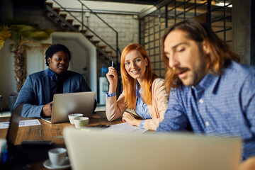 Young and diverse group of designers having a meeting in an office while working in a startup company