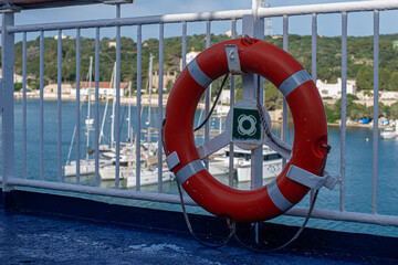 Obraz premium red lifebuoy on the handrail of a Mediterranean ferry