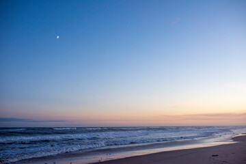 the moon on a clear beautiful early evening on an empty Amagansett, NY beach