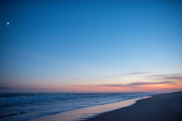 Fototapeta na wymiar sunset glow from Amagansett with the moon peaking above the horizon