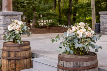 two large vases with floral arrangements for wedding