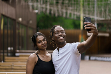 couple of african black persons making a selfie on a travel vacation, romance love tour - obrazy, fototapety, plakaty