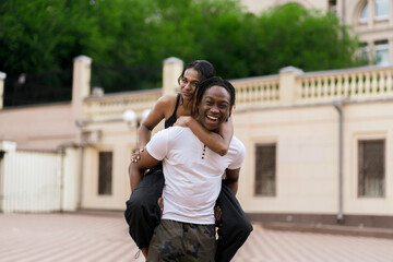 happy black male and female in love, cheerful couple outdoors