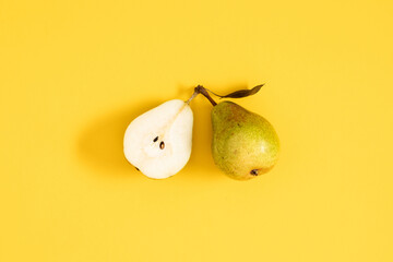 Yellow pears pattern. Close up of pear on yellow background. Autumn fruit concept from ripe juicy...