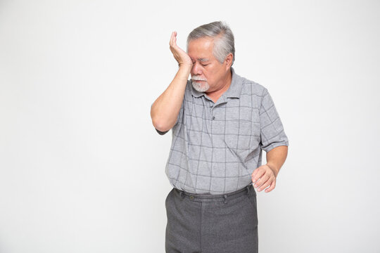 Asian senior man with eye pain isolated on white background, Diabetic Retinopathy, Pinguecula or Pterygium concept