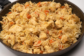 Tasty pilaf with chicken as background.
